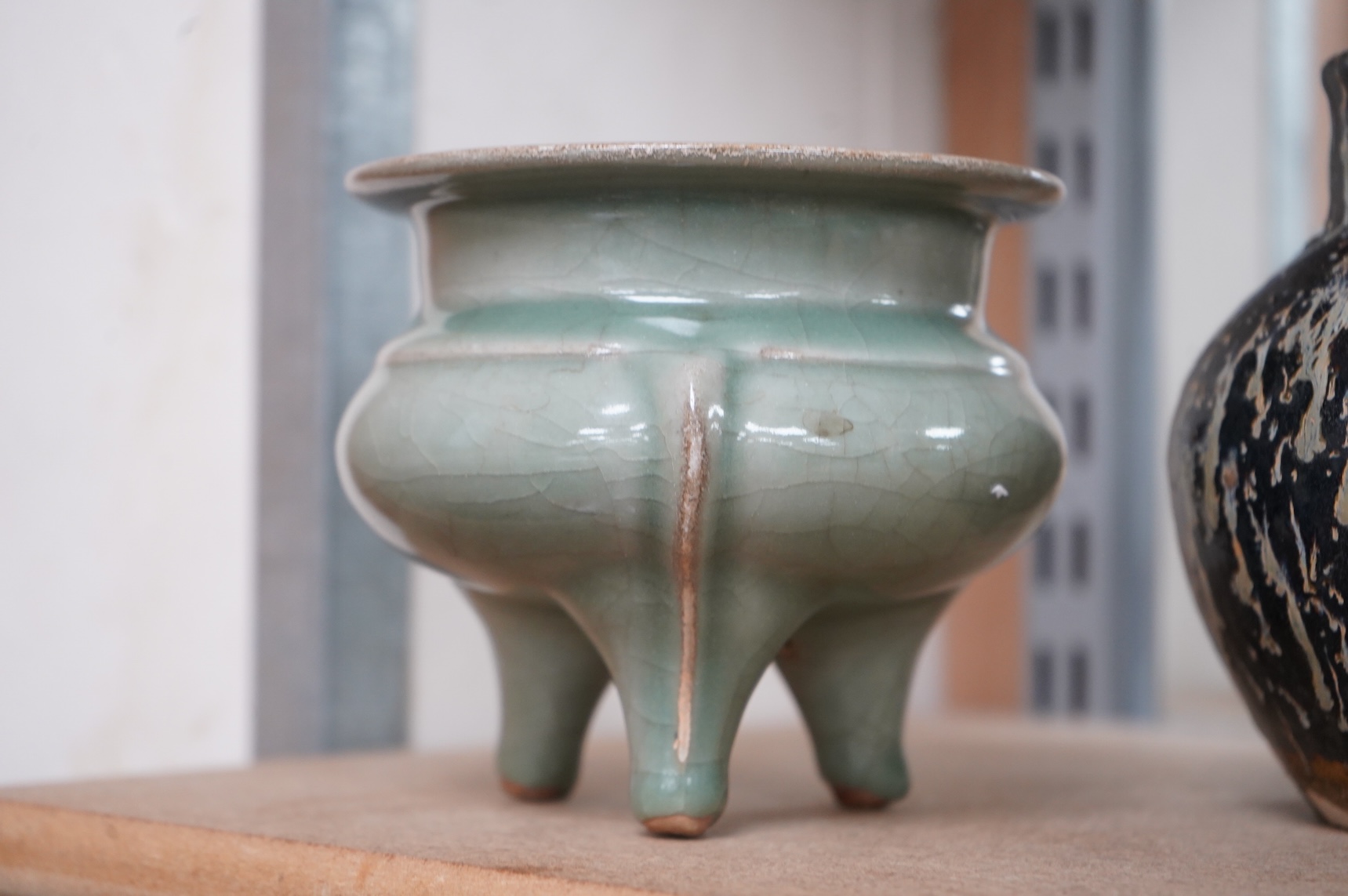 A Chinese celadon tripod censer and vase, largest 14cm high
